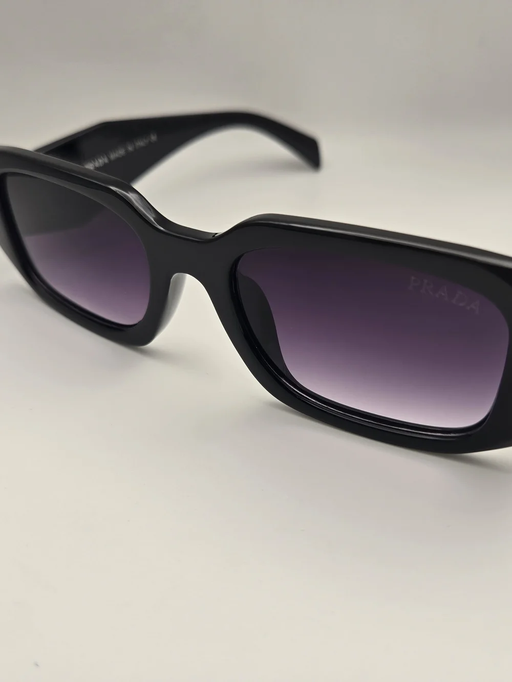 Prada Black Frame Sunglasses with Purple Gradient Lenses